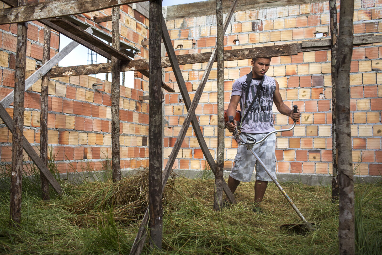 Tiago Garrido de Melo, 19, trabalha na construção de uma escola na comunidade baré de Nova Esperança, às margens de um afluente do rio Negro, a algumas horas de barco de Manaus, 2014, da série Offside Brazil. 30 x 42 cm. Foto de André Vieira. Coleção de Arte Contemporânea / Acervo IMS 